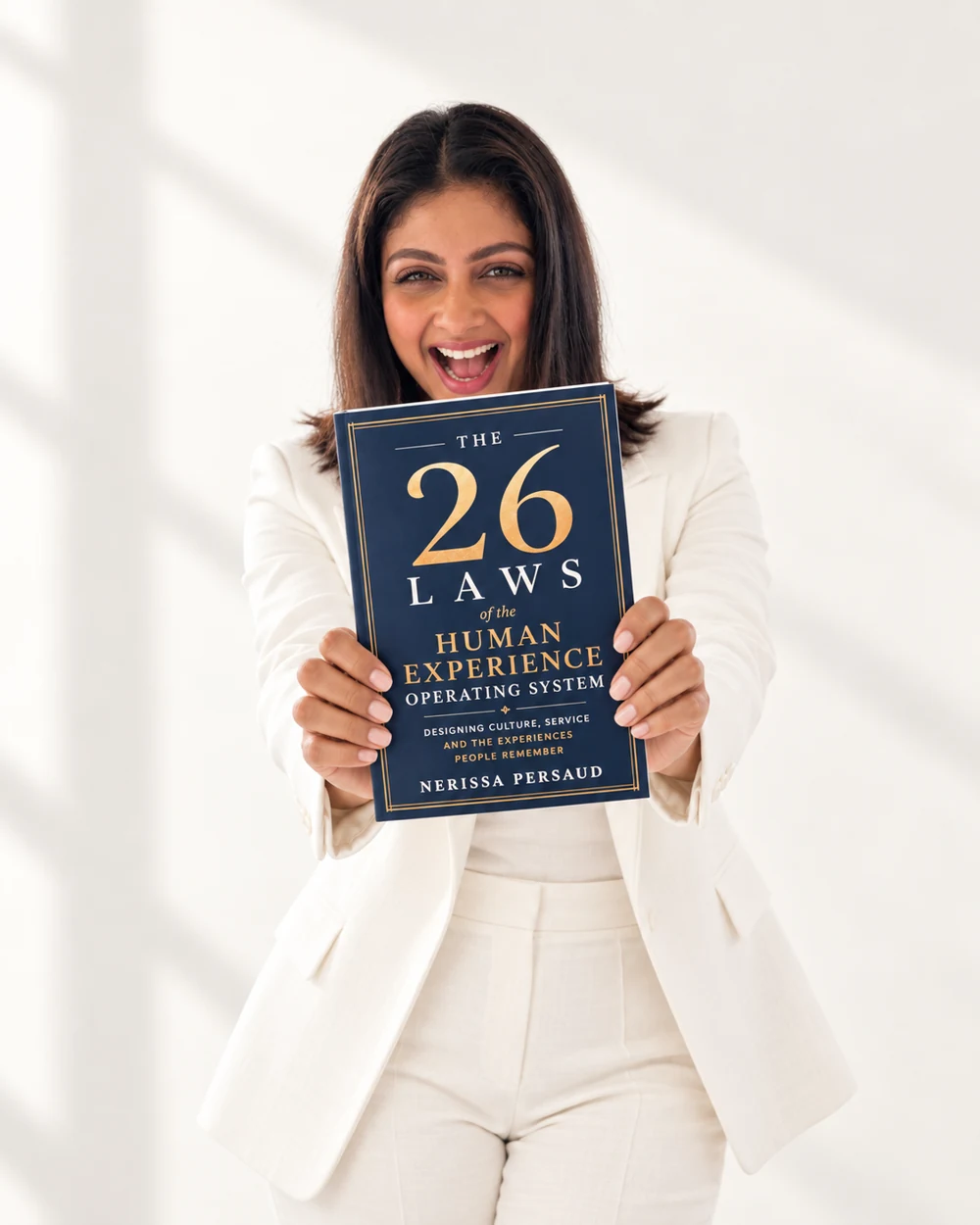 Nerissa smiling as she holds The 26 Laws